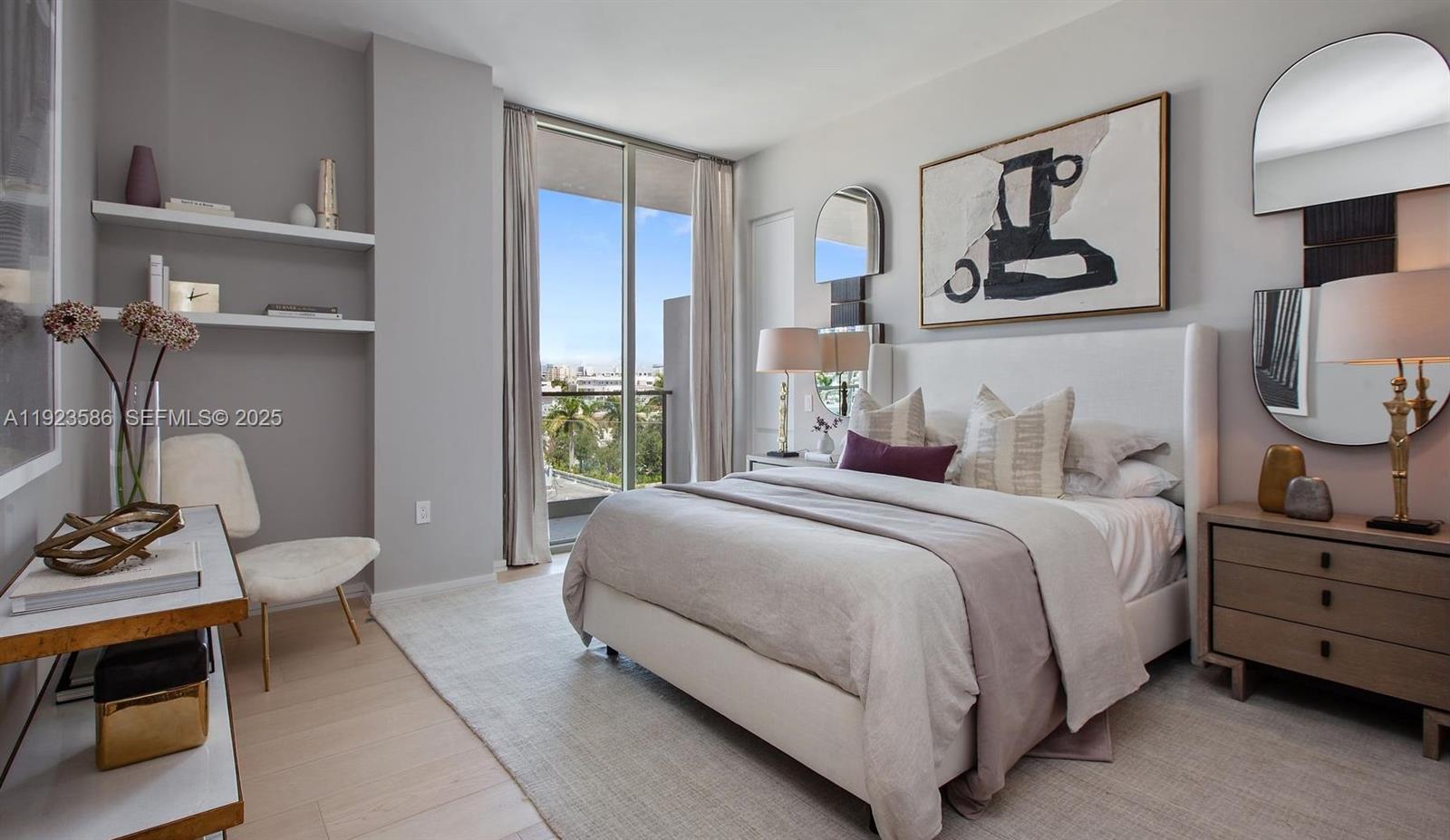 300 Collins Avenue, Unit PH2 Miami Beach, FL 33139 - Photo 10 of 21 a bedroom with a bed a mirror and lamp next to a window