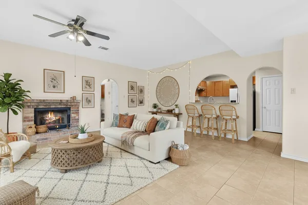 a living room with furniture and a fireplace