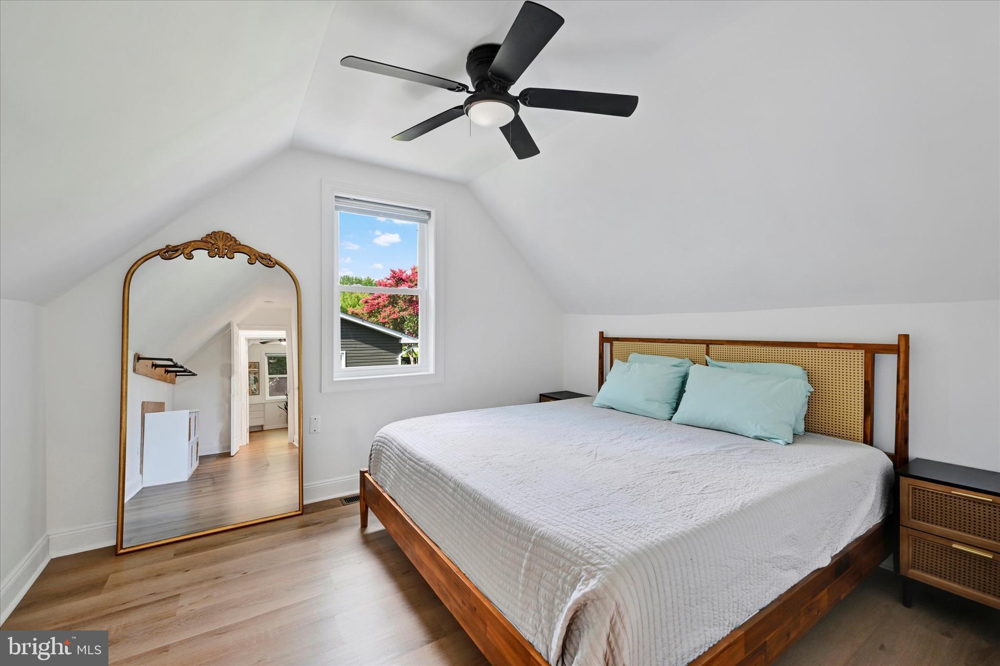 102 Maple Road Stevensville, MD 21666 - Photo 22 of 43 a bedroom with a bed and a chandelier