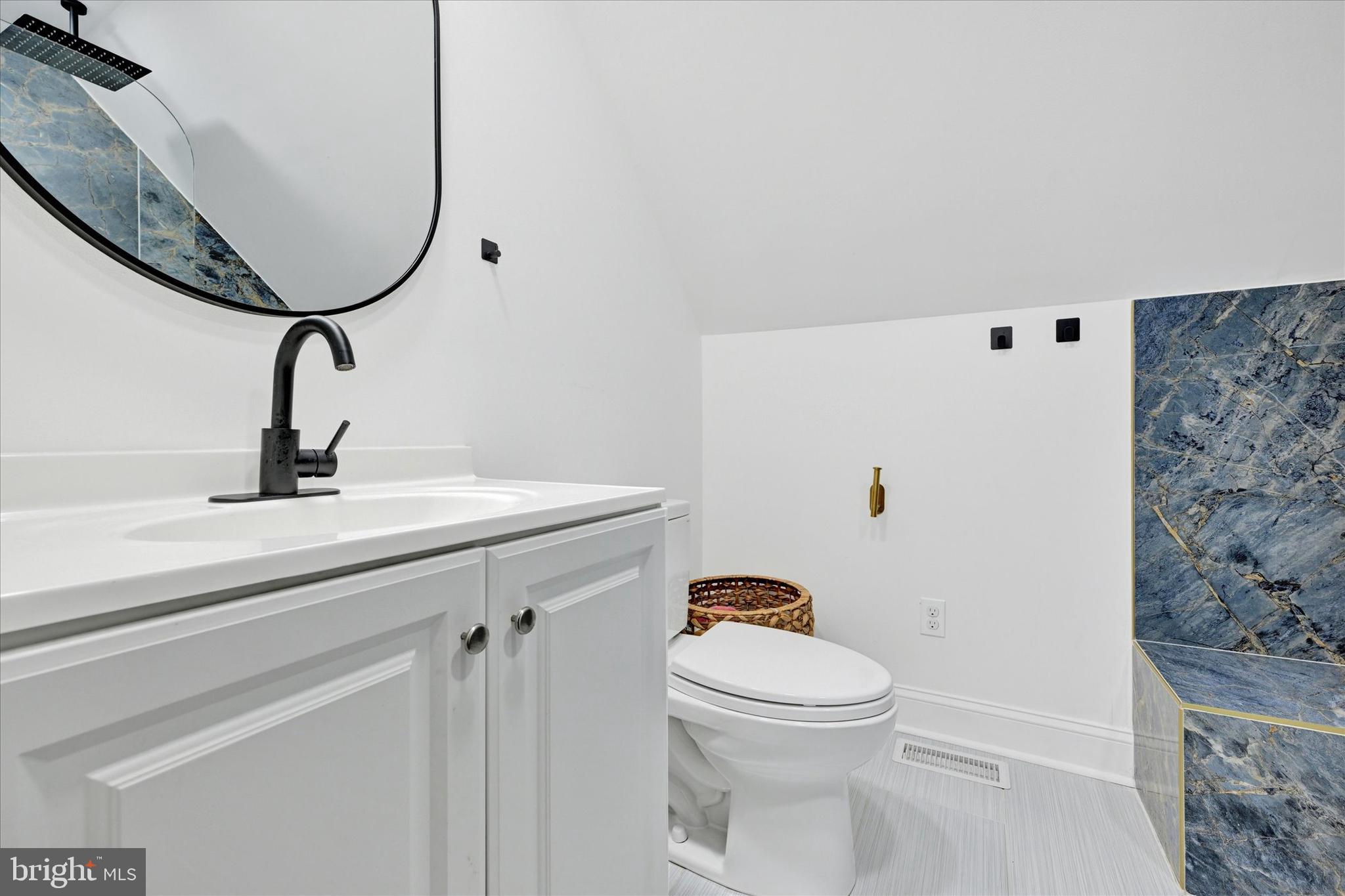 102 Maple Road Stevensville, MD 21666 - Photo 25 of 43 a bathroom with a sink a toilet and a mirror