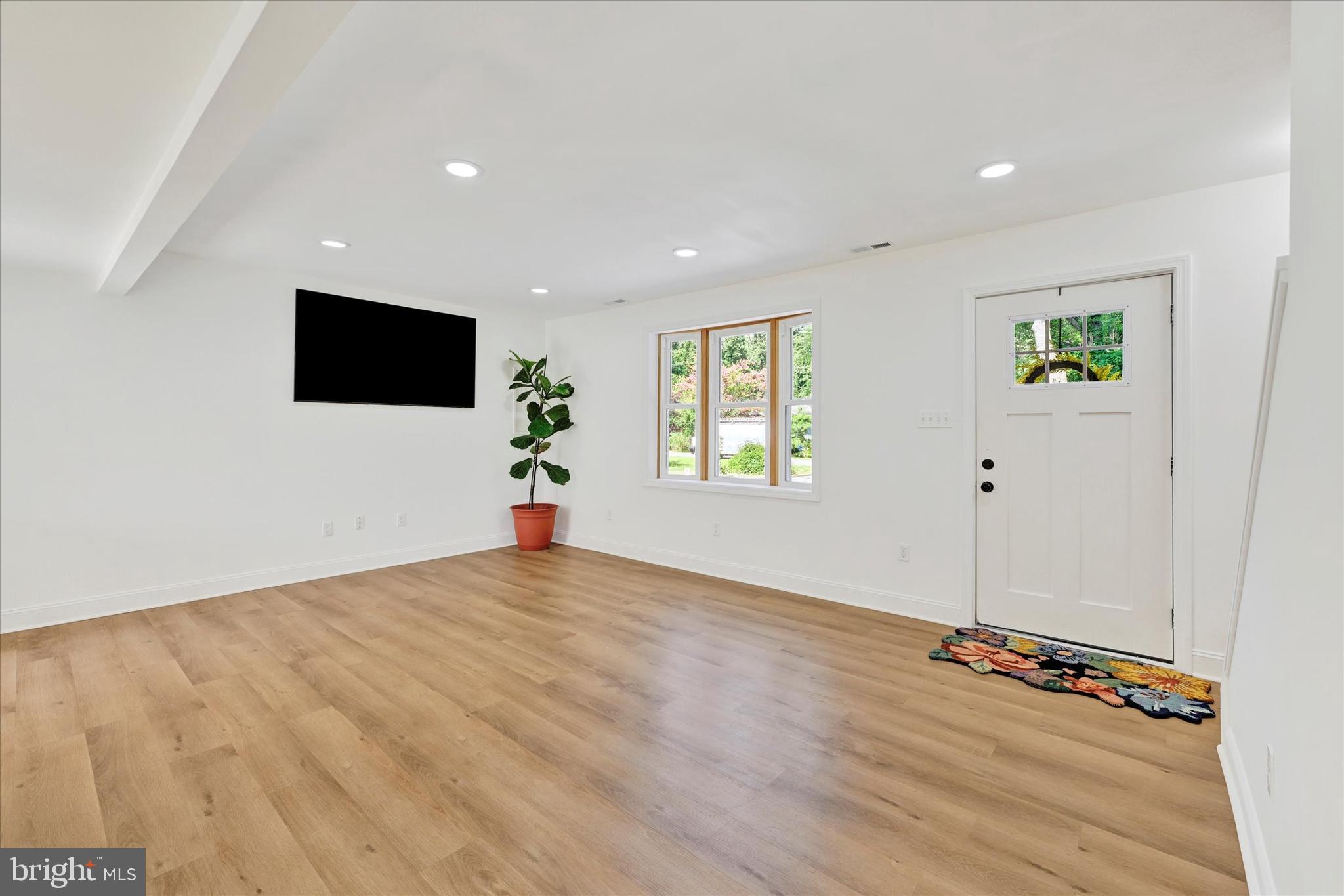 102 Maple Road Stevensville, MD 21666 - Photo 5 of 43 a view of an empty room with wooden floor and a window