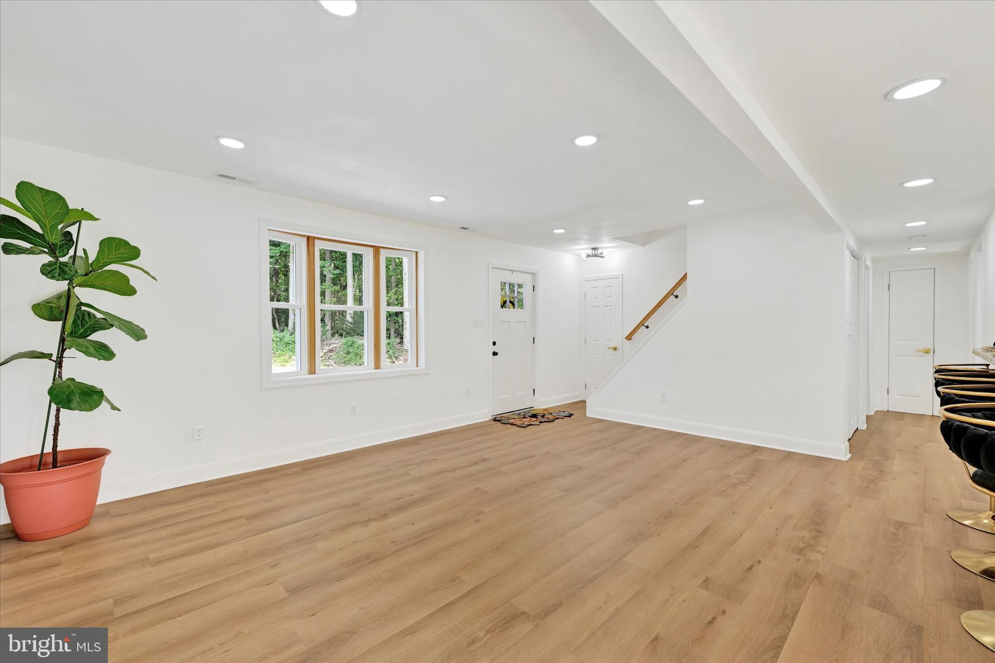 102 Maple Road Stevensville, MD 21666 - Photo 6 of 43 a view of an empty room with wooden floor and a window
