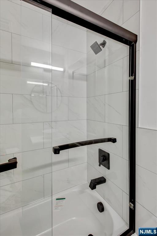 581 Bergen Street Newark, NJ 07108 - Photo 21 of 21 a bathroom with a shower and a mirror