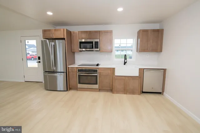 a kitchen with stainless steel appliances a refrigerator sink and microwave