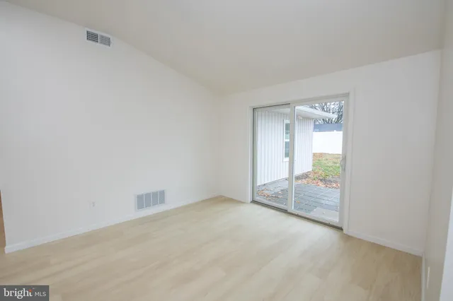 a view of an empty room with glass door