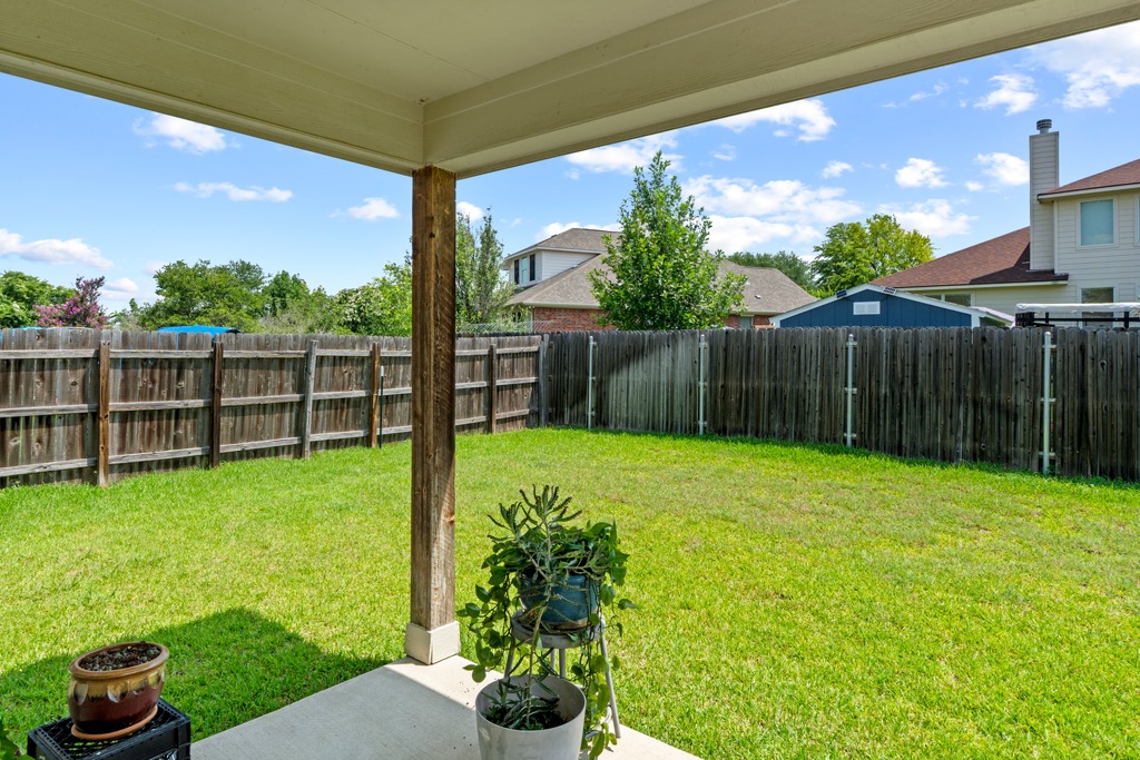 12008 Lansdowne Road Austin, TX 78754 - Photo 25 of 29 A spacious, enclosed backyard offers abundant green space for recreation and relaxation.