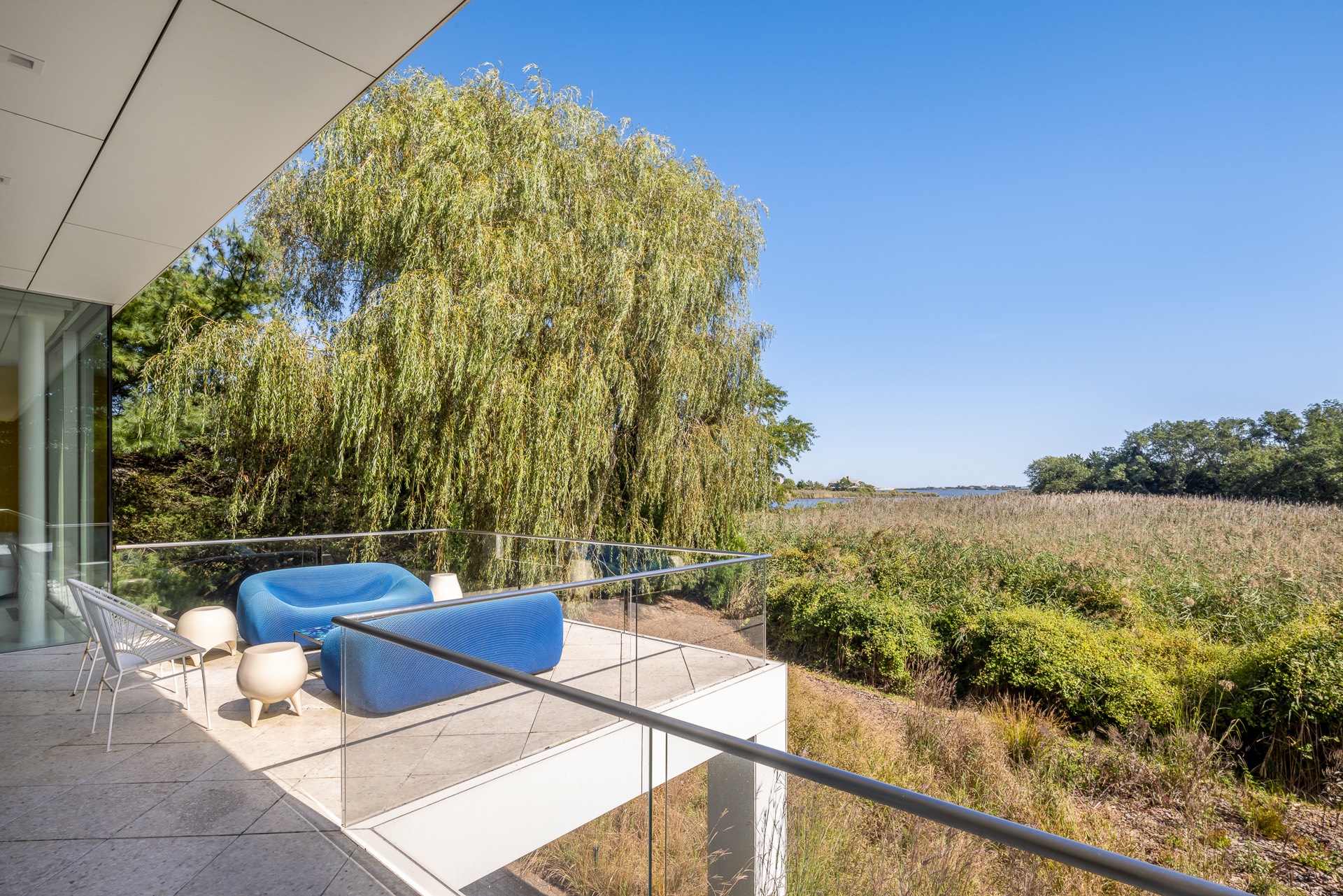 34 Cobb Isle Road Water Mill, NY 11976 - Photo 17 of 37 a view of a balcony with chair and table