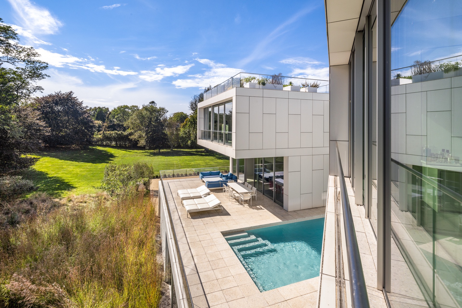 34 Cobb Isle Road Water Mill, NY 11976 - Photo 23 of 37 a view of swimming pool outdoor seating and city view