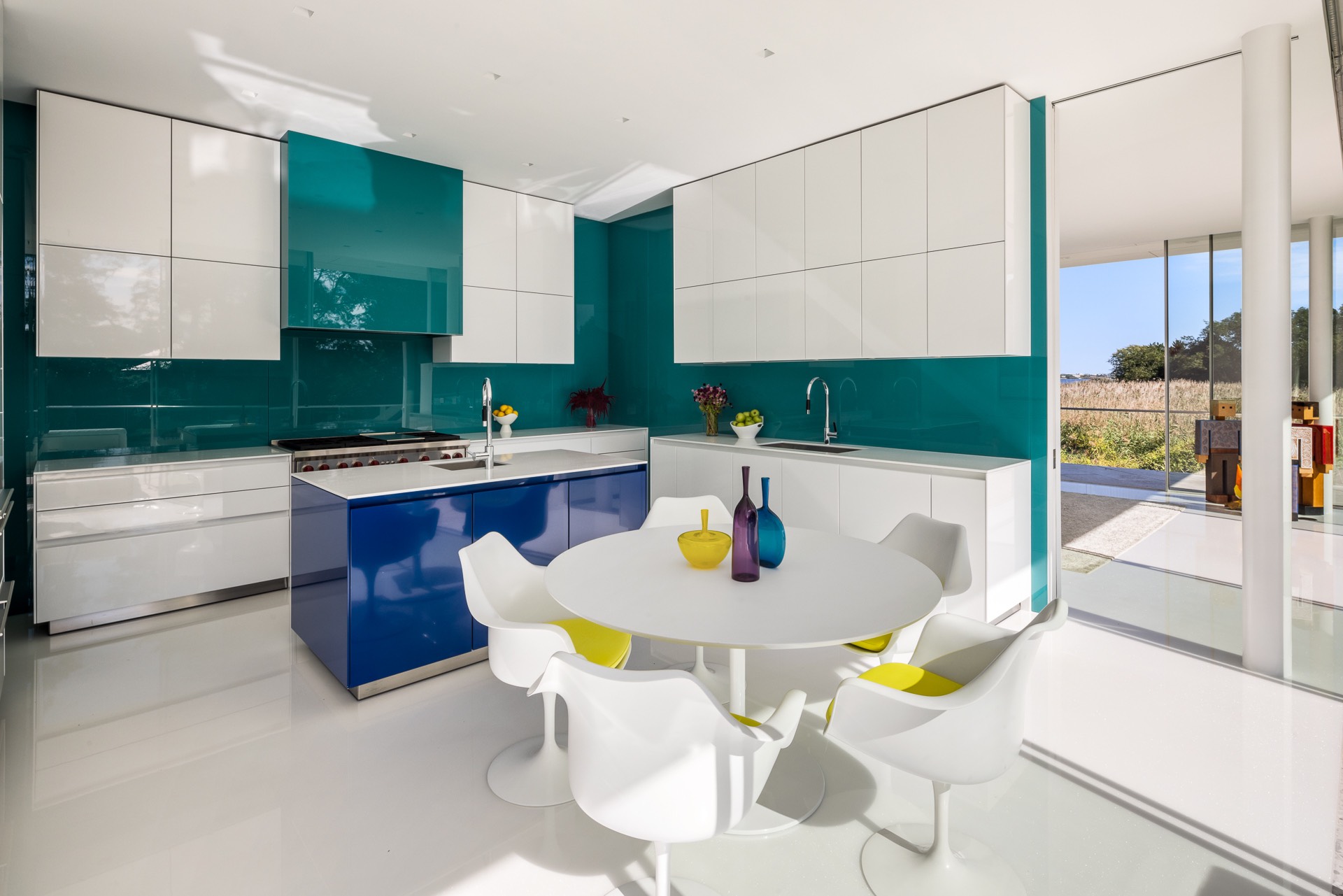 34 Cobb Isle Road Water Mill, NY 11976 - Photo 26 of 37 a kitchen with a sink a counter and chairs