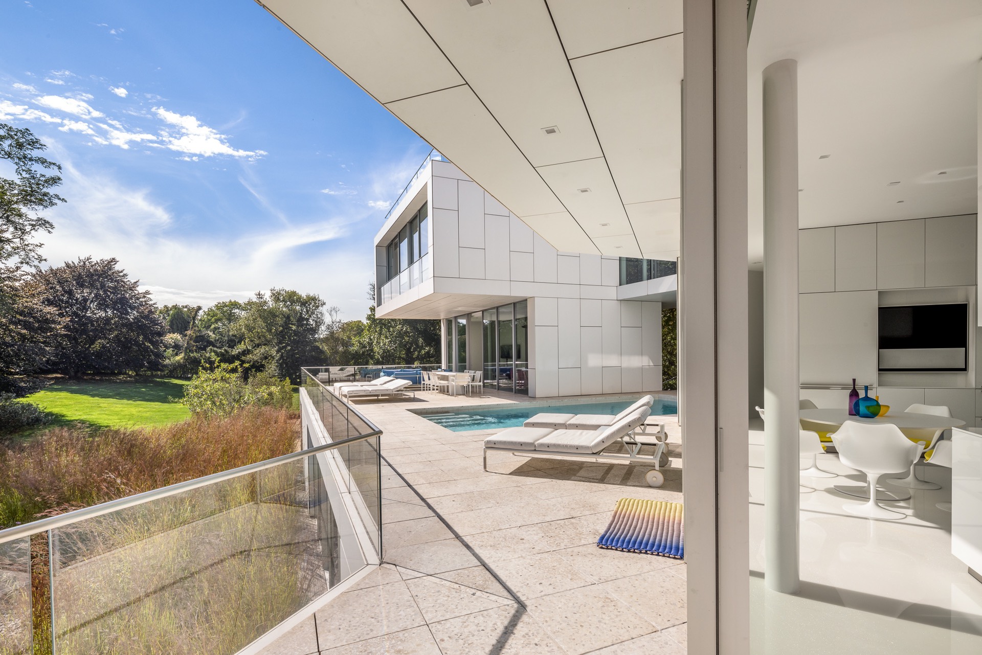 34 Cobb Isle Road Water Mill, NY 11976 - Photo 29 of 37 a view of a patio with table and chairs near a yard