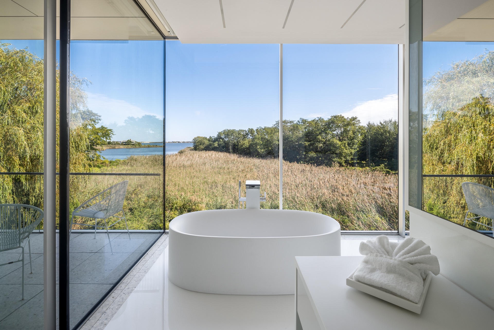 34 Cobb Isle Road Water Mill, NY 11976 - Photo 10 of 37 a living room with a large window and a table