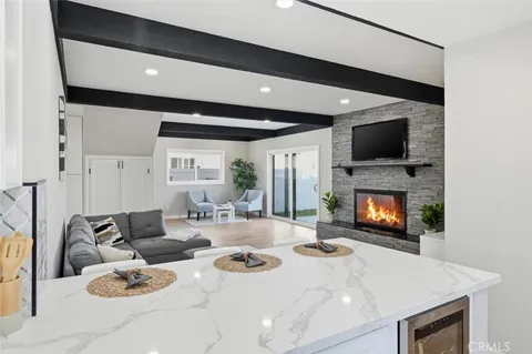 a kitchen with a refrigerator and white cabinets