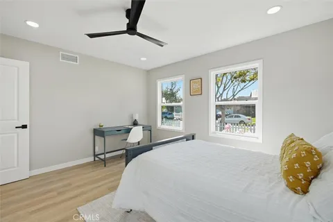 a bedroom with furniture and wooden floor