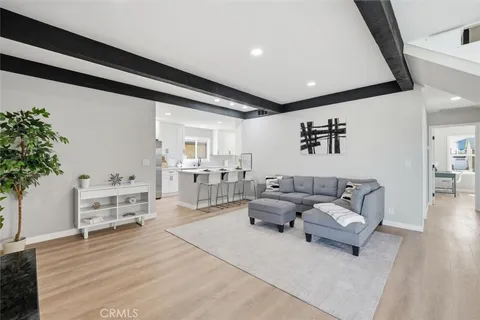 a living room with furniture and flowers
