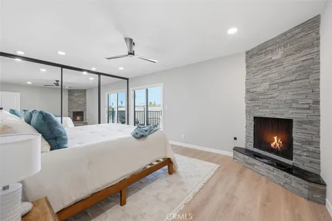 a bed room with a bed and a ceiling fan