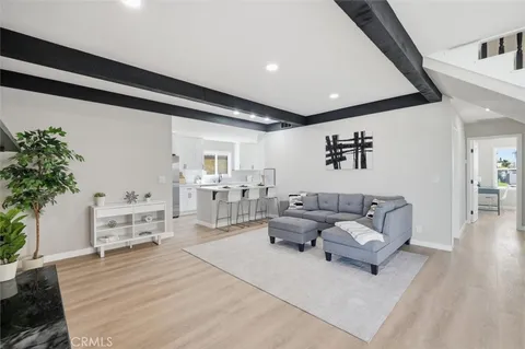 a living room with furniture and flowers