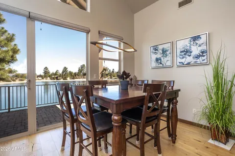 a view of a dining room with furniture and window
