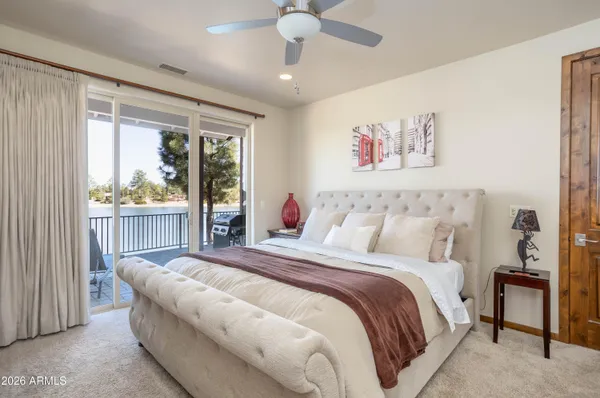 a bedroom with a large bed and a window