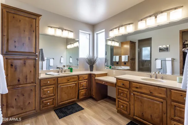 a spacious bathroom with a granite countertop sink a mirror and a window