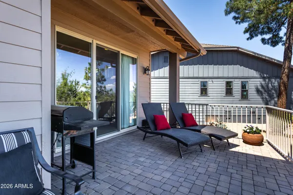 a view of a porch with chairs and a couch