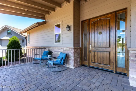 a backyard of a house with barbeque oven table and chairs