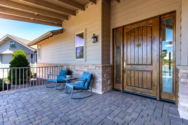 a backyard of a house with barbeque oven table and chairs
