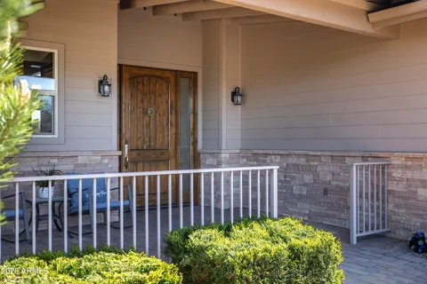 a view of a house with a wooden fence