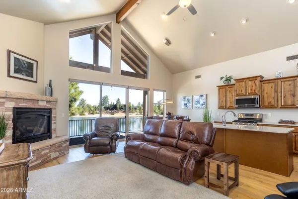a living room with furniture a fireplace and a large window