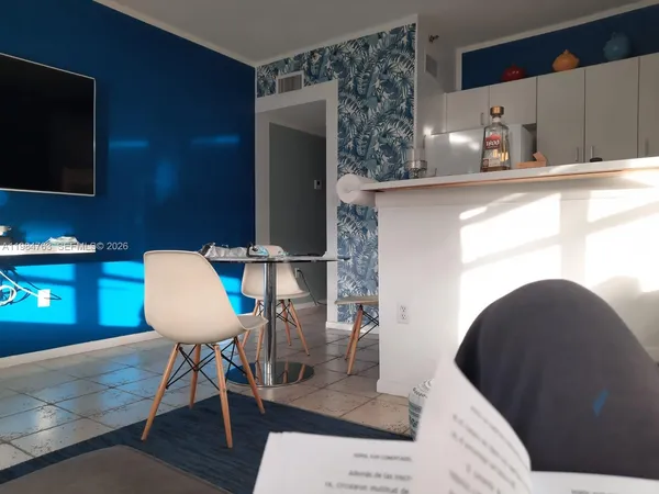 a dining room with furniture and wooden floor