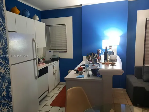 a kitchen with sink refrigerator and cabinets