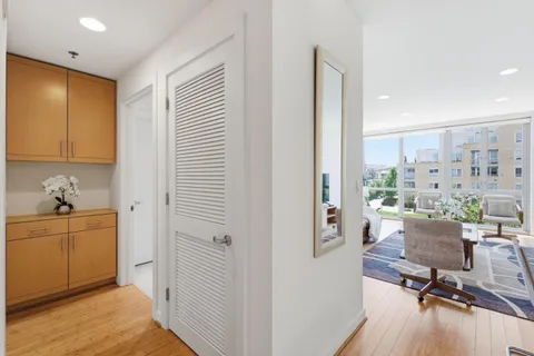 a view of a kitchen with furniture and wooden floor