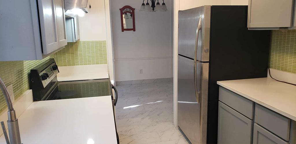 125 Sputnik Street Fortson, GA 31808 - Photo 3 of 30 a kitchen with a refrigerator and a sink