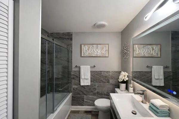a bathroom with a sink toilet and shower