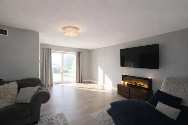 a living room with furniture and a flat screen tv