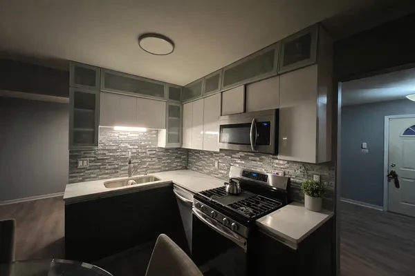 a kitchen with granite countertop a stove and a sink