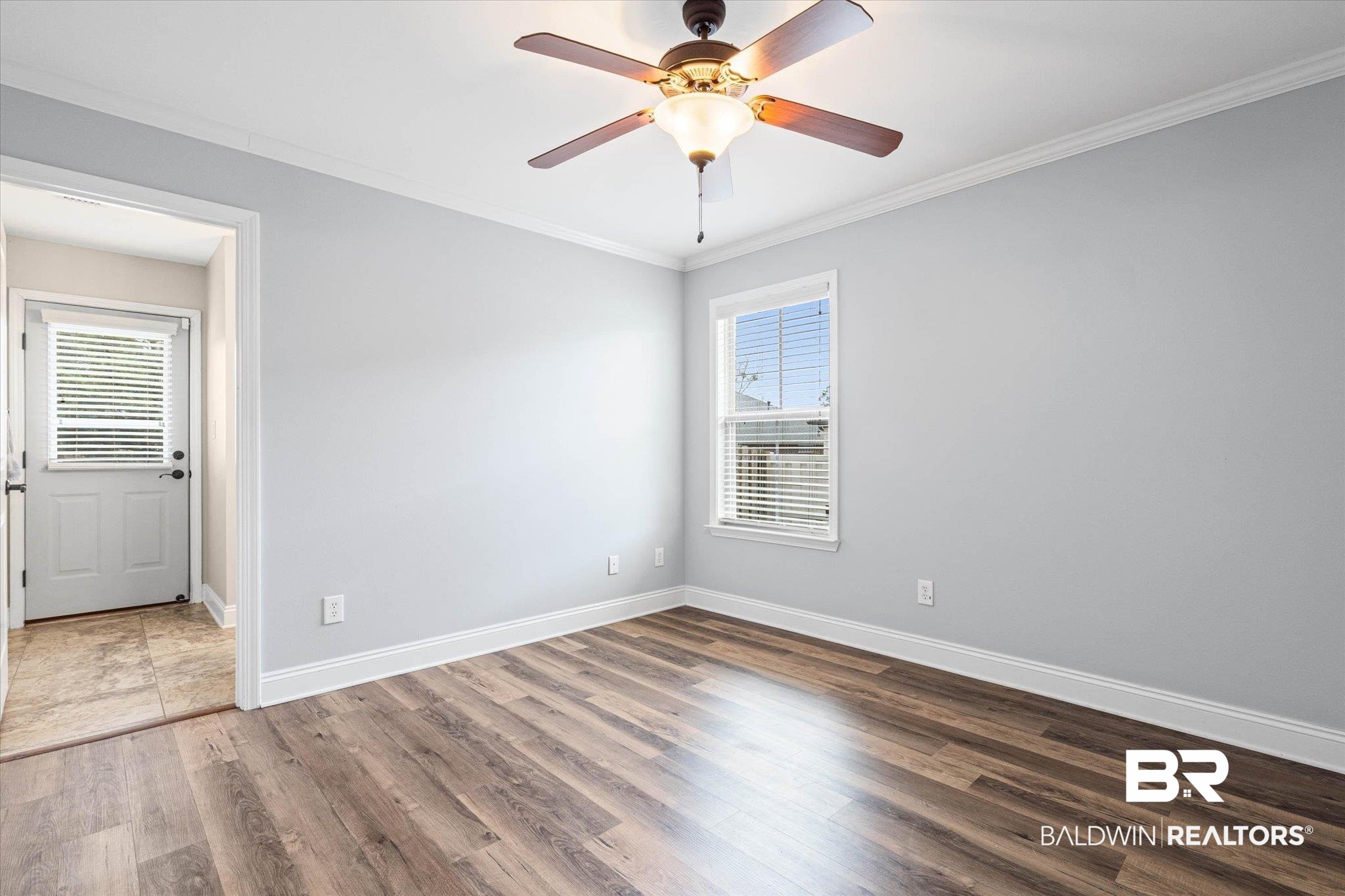 704 Edinburgh Avenue Foley, AL 36535 - Photo 25 of 32 Spare room with ornamental molding, dark wood-type flooring, and a ceiling fan