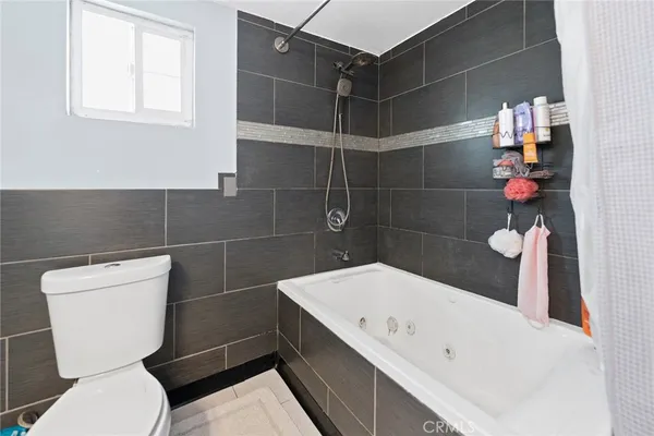 a bathroom with a bathtub and toilet