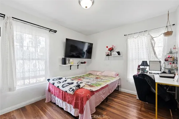 a bedroom with a bed and a flat screen tv