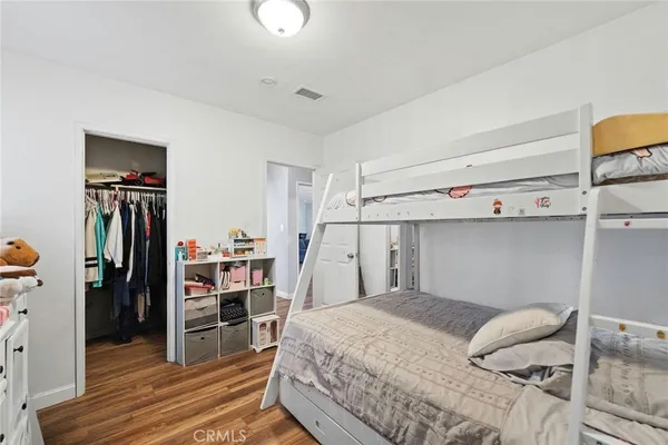 a bedroom with a bed and a book shelf