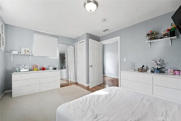 a room with a bed and cabinets