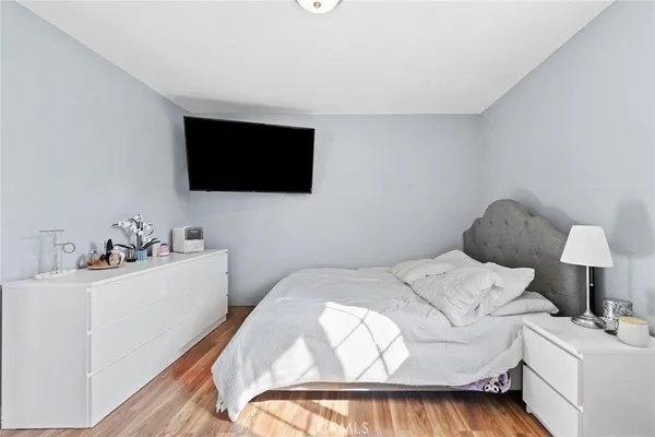 a bedroom with a bed and a flat screen tv