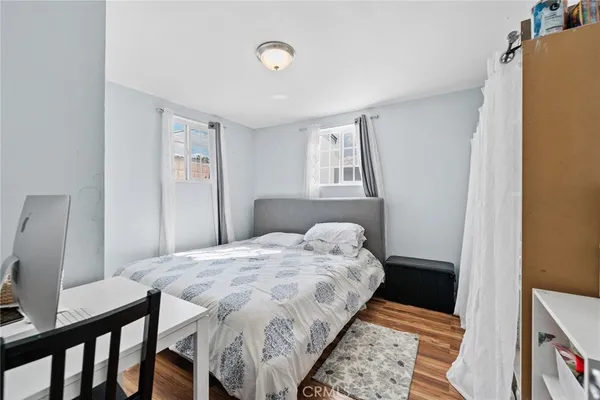 a bed sitting in a bedroom next to a window