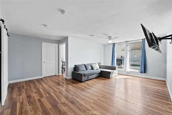 a living room with furniture and wooden floor