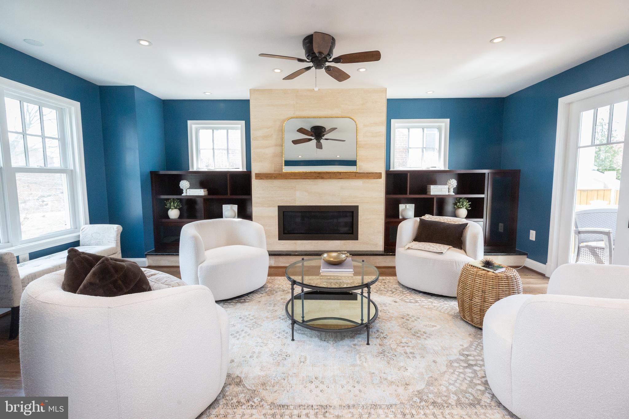 1213 Forest Glen Road Silver Spring, MD 20901 - Photo 11 of 57 a living room with furniture a fireplace and a chandelier