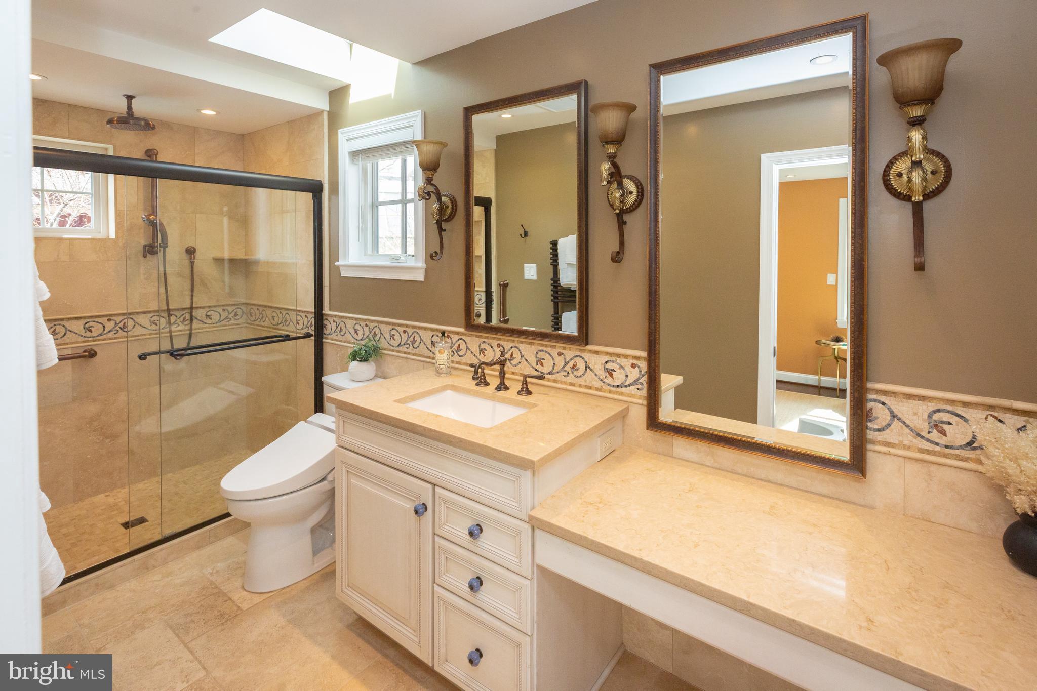 1213 Forest Glen Road Silver Spring, MD 20901 - Photo 20 of 57 a bathroom with a granite countertop toilet sink and mirror