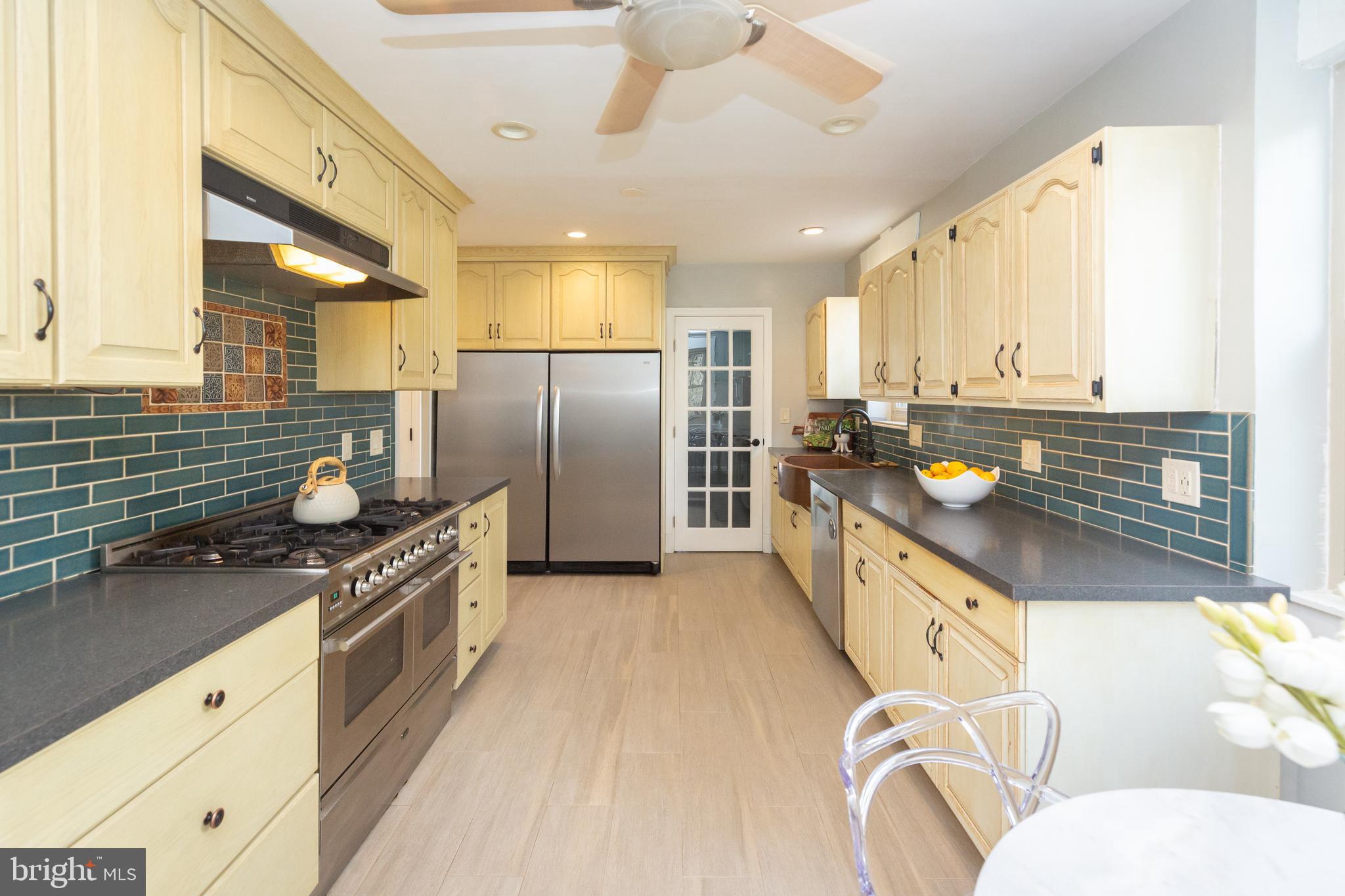 1213 Forest Glen Road Silver Spring, MD 20901 - Photo 21 of 57 a kitchen with stainless steel appliances granite countertop a sink a stove and a refrigerator