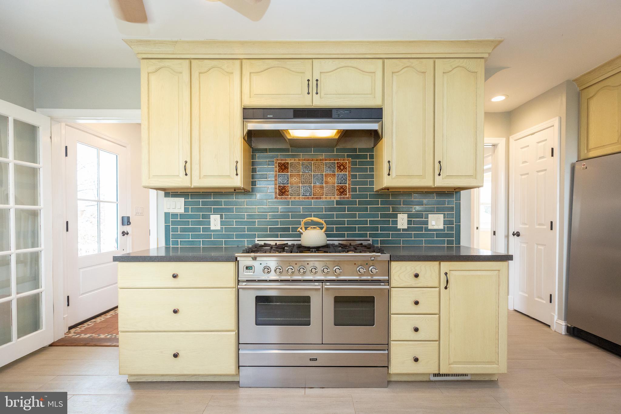 1213 Forest Glen Road Silver Spring, MD 20901 - Photo 24 of 57 a kitchen with granite countertop a stove and a sink