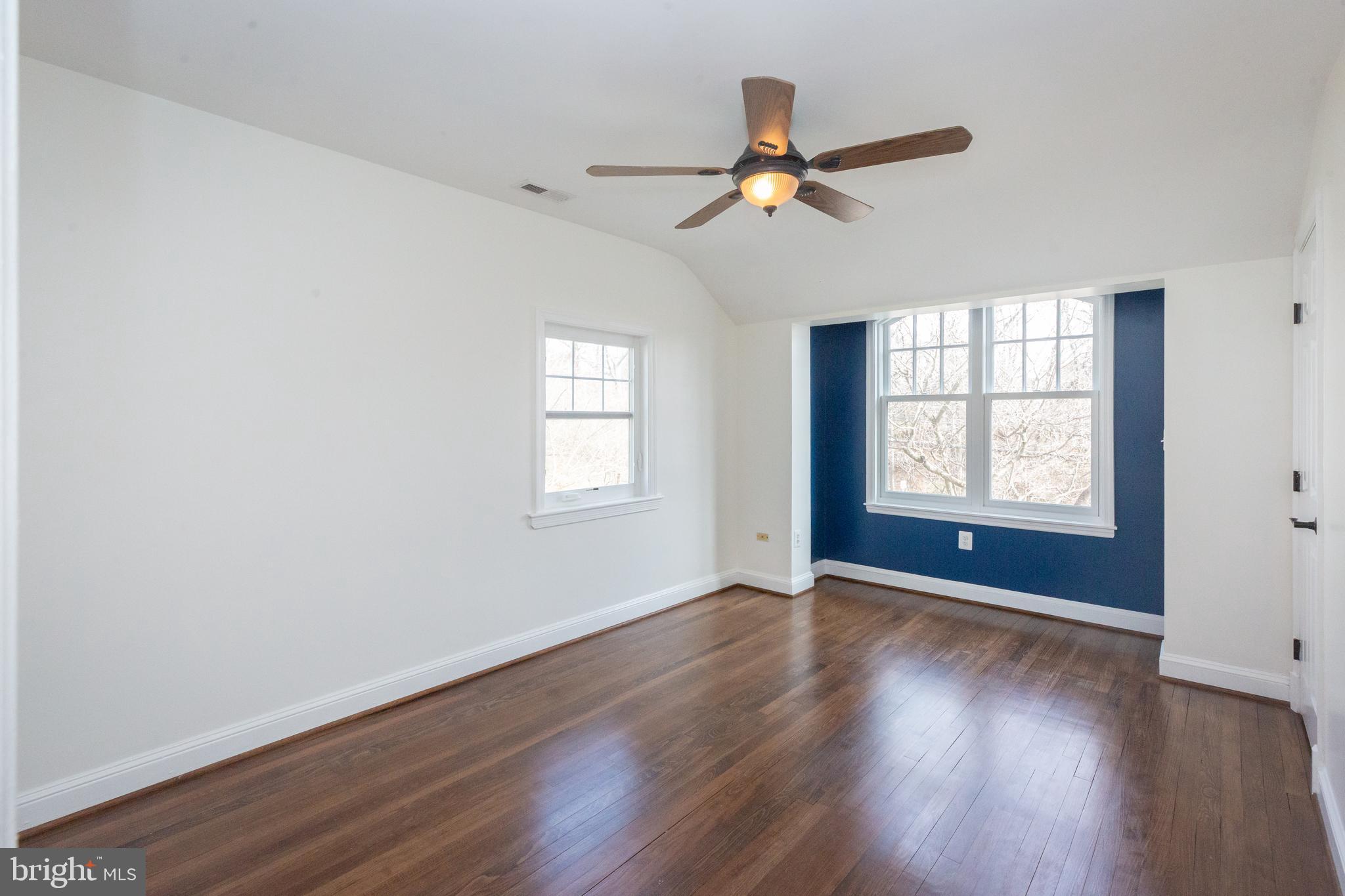 1213 Forest Glen Road Silver Spring, MD 20901 - Photo 33 of 57 a view of an empty room with wooden floor and a window