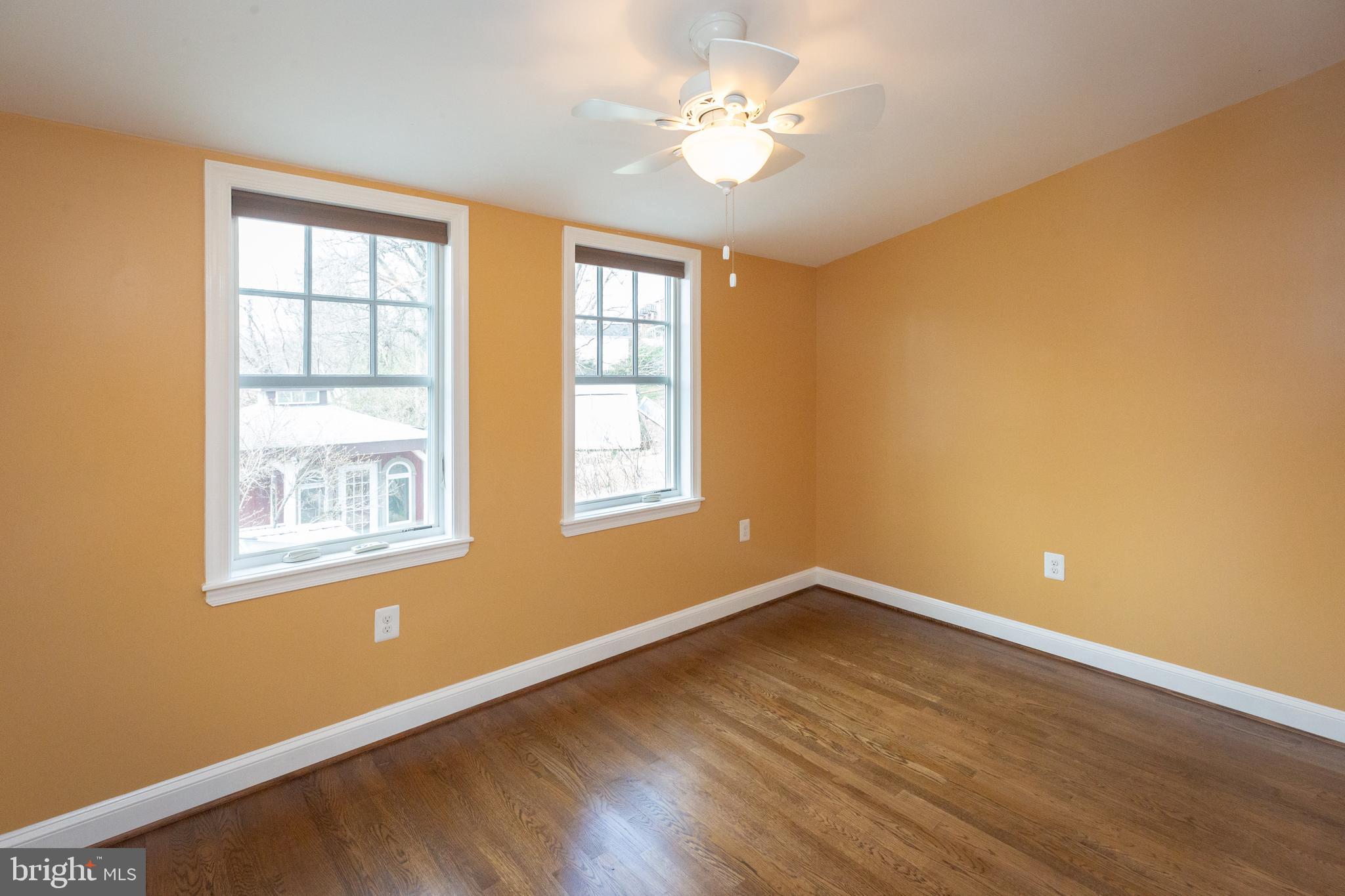 1213 Forest Glen Road Silver Spring, MD 20901 - Photo 34 of 57 a view of an empty room with a window and wooden floor