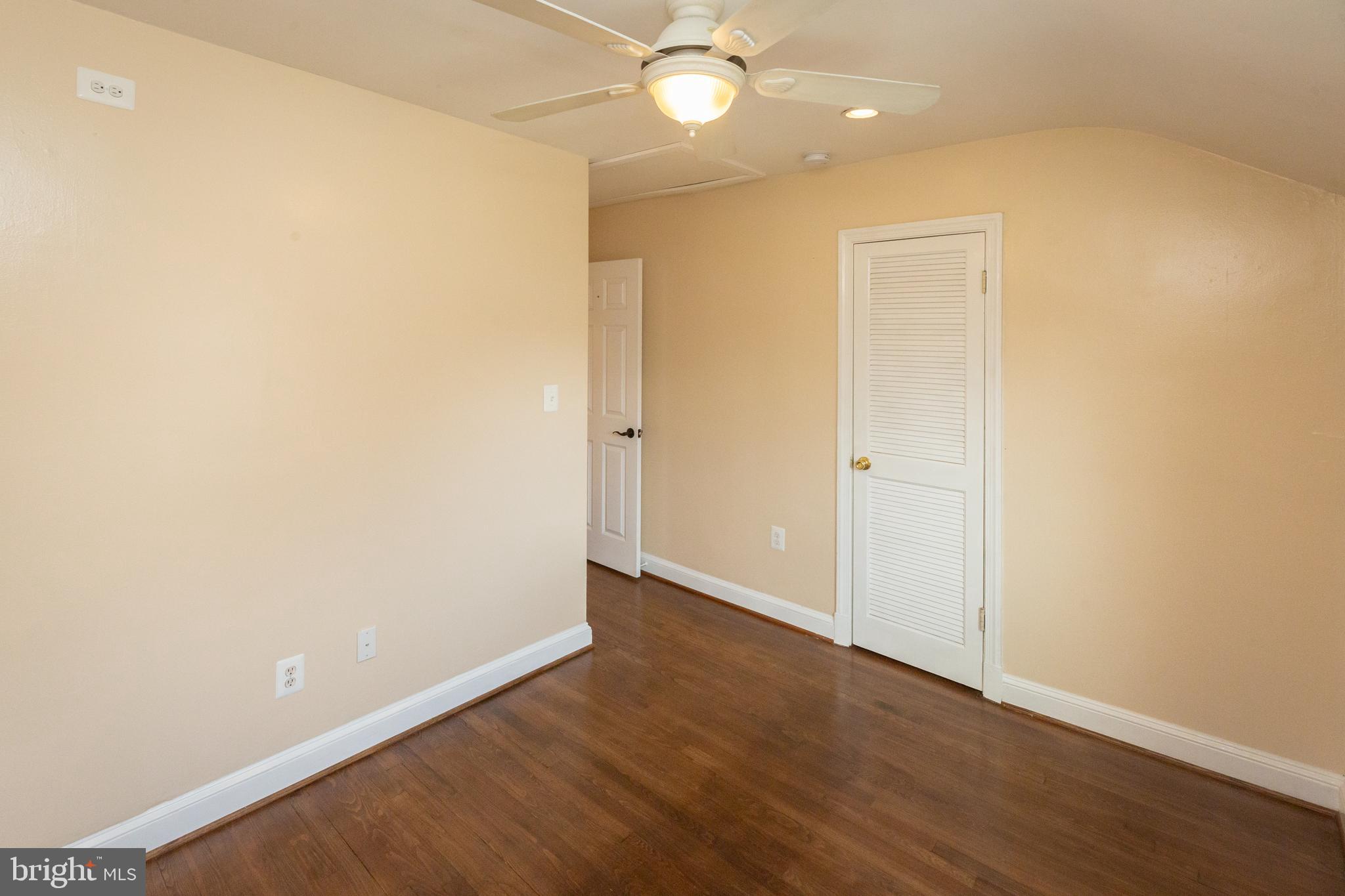 1213 Forest Glen Road Silver Spring, MD 20901 - Photo 35 of 57 an empty room with wooden floor and fan